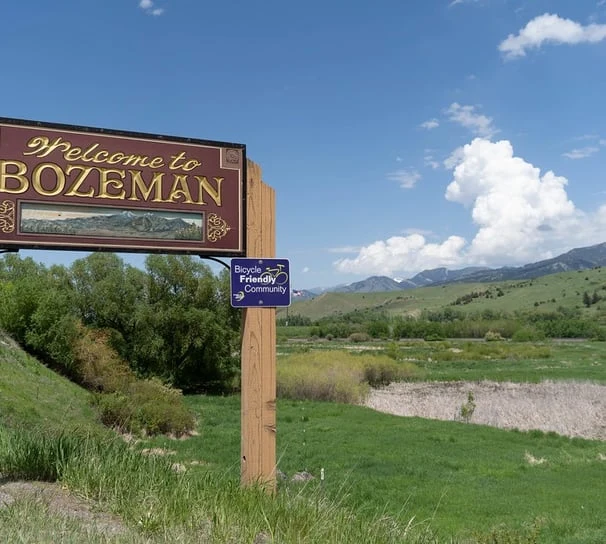 The Welcome to Bozeman sign with mountains beyond